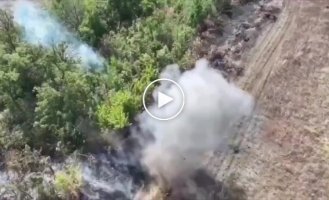 Pieces of the body of a Russian invader fly high into the air after a grenade is dropped