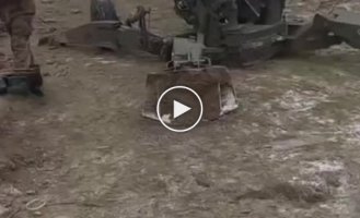Ukrainian soldiers fire from a 155 mm M777 howitzer in winter