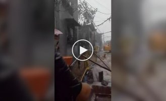 In the Philippines, a little boy was washed away by streams of water into a road under construction
