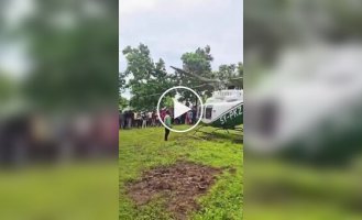 Air show: a guest hangs from a helicopter at a wedding
