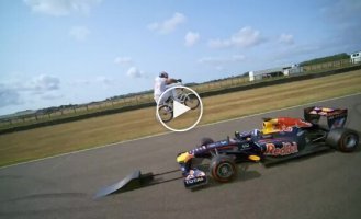 BMX bike jump over Formula 1 car