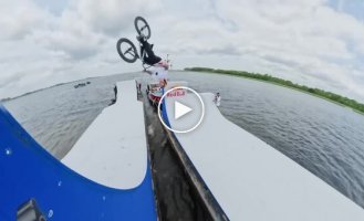 A BMX stunt between floating boats