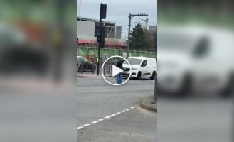 In London, a passerby helped direct traffic after a traffic light failed