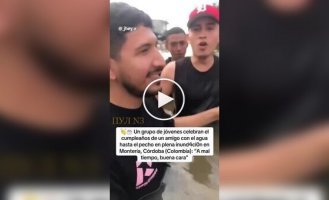 In Colombia, residents held a celebration chest-deep in water, using an inflatable mattress as a table