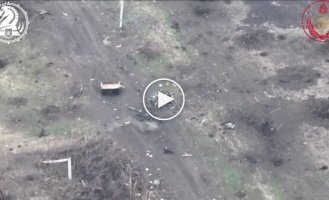 An occupant tries to shoot down a kamikaze drone by throwing a stone at it