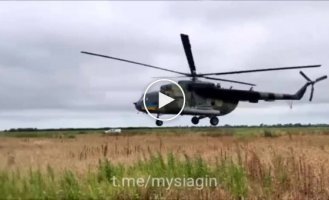 A pair of Ukrainian Mi-8 combat helicopters, at very low altitudes, almost touching the black soil, work on Russian targets