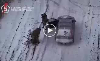 Soldiers of the 5th separate airborne brigade jump out of a car and take prisoner a Russian who was standing alone in a field