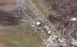 A soldier destroys a Russian attack aircraft with machine gun fire that got entangled in barbed wire