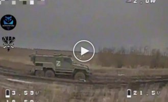 A drone attacks an enemy armored vehicle stuck in the ground