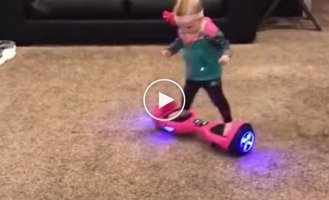 A 16-month-old girl masterfully rides a hoverboard