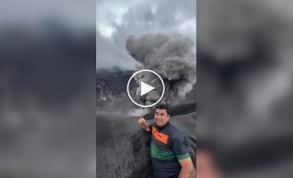 On the brink of risk: a man took a selfie against the backdrop of an erupting volcano