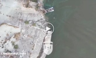 Occupiers, bleeding, swim around their boat after drops from a Ukrainian drone