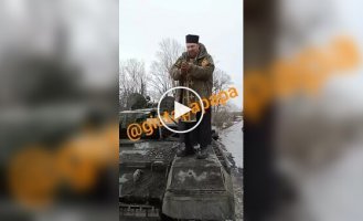 A Russian priest climbed onto a tank and blessed the invaders for war