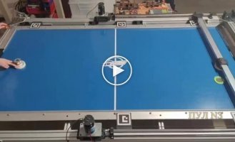 Air hockey-playing robot