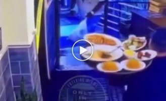 An inadequate person knocked a tray of food off a waiter's hands