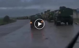A huge column of Ukrainian armored vehicles Oshkosh M-ATV and tankers of the Armed Forces of Ukraine on one of the roads on the way to the front line