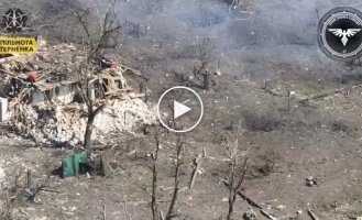 A kamikaze drone attacks a group of invaders hiding in a dilapidated house