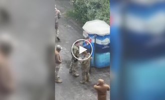 Four TCC servicemen watch as their colleague carries out warning measures in Kharkov and beats up a man in civilian clothes