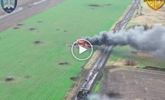 The body of an occupier lies near an infantry fighting vehicle set on fire by Ukrainian drones