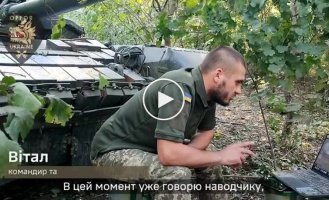 A Ukrainian tankman on the move during a combat mission extinguishes the flame from a fire extinguisher after being hit by an enemy drone