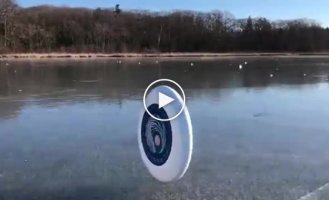 The wind plays with a frisbee on the lake