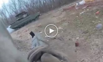 An RDK soldier fires an RPG at a Russian tank in the village of Kozinka, Belgorod Region