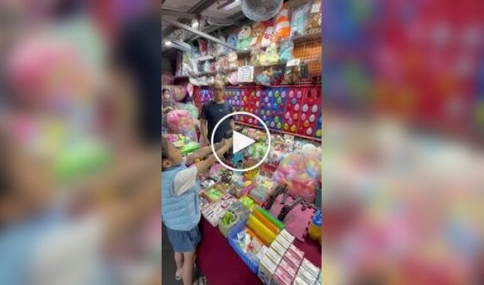 A girl popped all the balloons at a shooting range without missing
