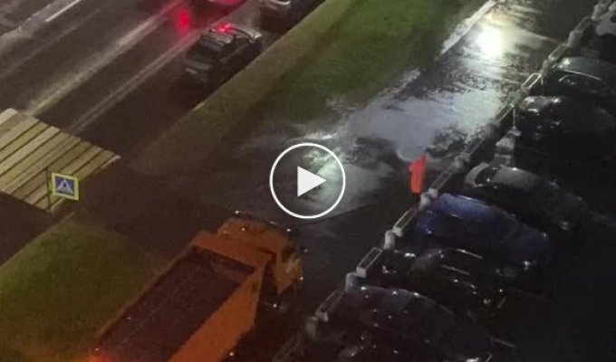 St. Petersburg public utilities wash the asphalt in the pouring rain