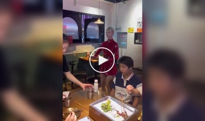 A waitress impersonates a robot