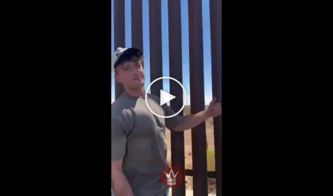 A man is trying to check how easy it is to cross the wall on the US-Mexico border