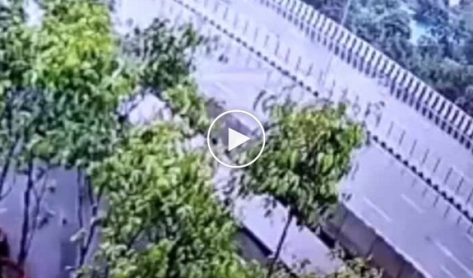 The SUV flew over the fence, landed on a passenger car in India