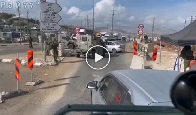 An Israeli armored vehicle overturned, ramming a car at a checkpoint