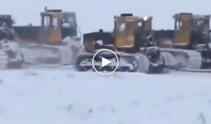 Tractors drag an unusual object