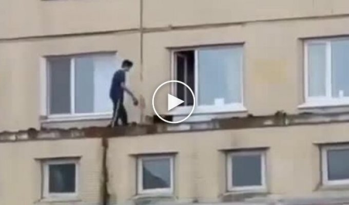 In Russia, a guy walks his dog along the ledge in front of his neighbors' windows