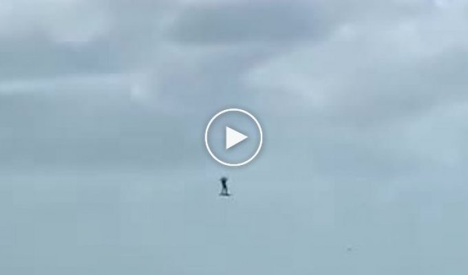 The kite lifted the surfer into the sky several tens of meters