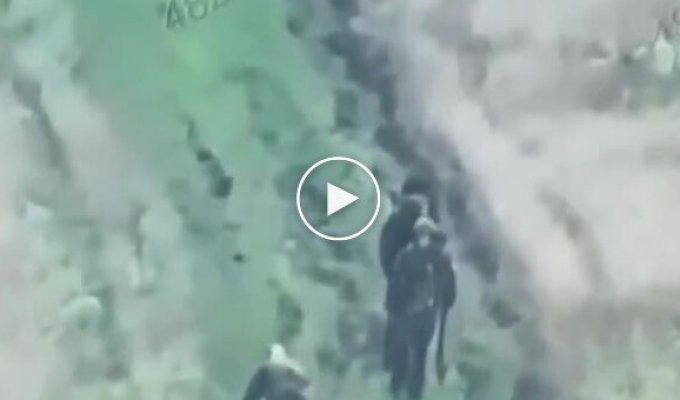 Two occupiers pass by their wounded comrade, who crawls towards them on all fours.