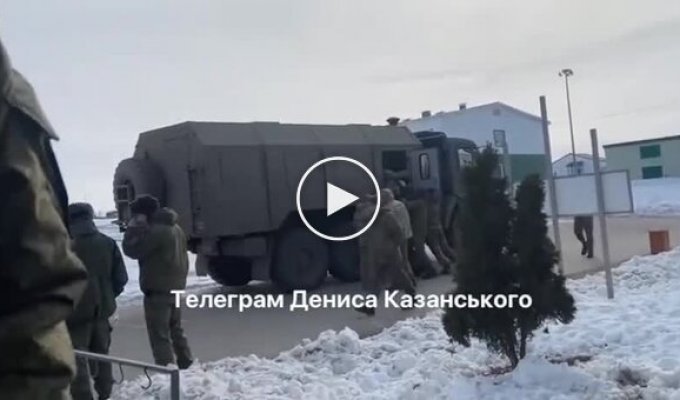 Five big guys in Russian army uniform stuff an occupier with a crutch into a KamAZ and send him to war