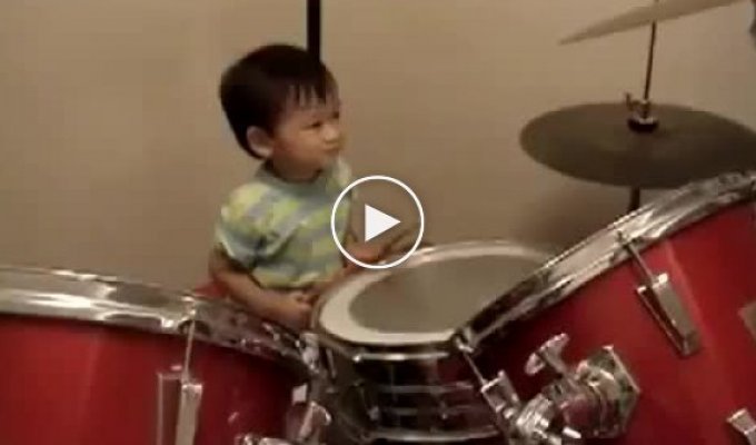 One year old child plays drums