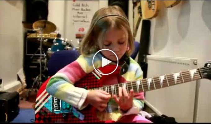 6 year old girl playing guitar
