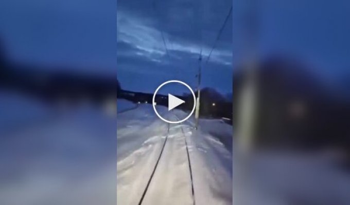 The train travels on a snowy road