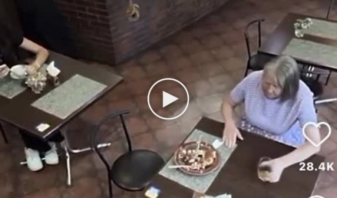 A woman was sitting in a cafe and waiting for the man at the next table to leave so she could finish his breakfast.