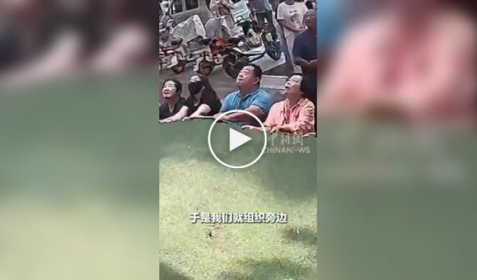 A woman who was hanging at the third floor level was rescued in China