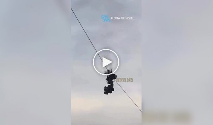 Suspended camera It caught fire and fell onto a football field.