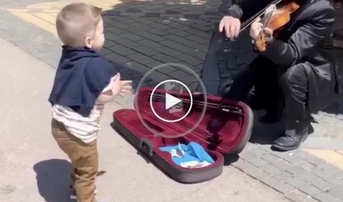 The boy started dancing near a street musician