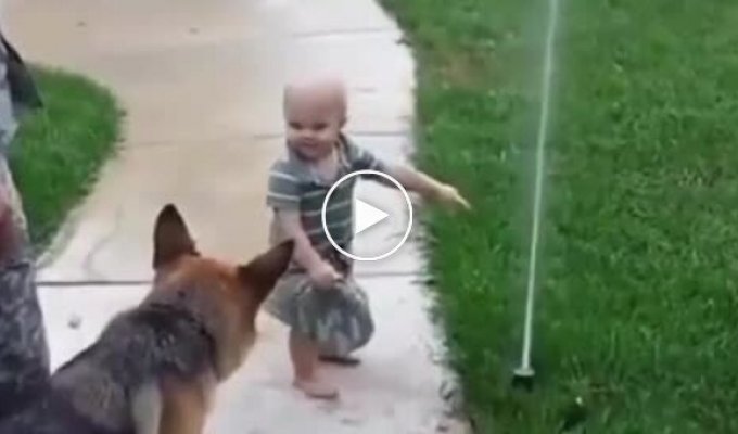 Kid shows his friend that there is no need to be afraid of the sprinkler