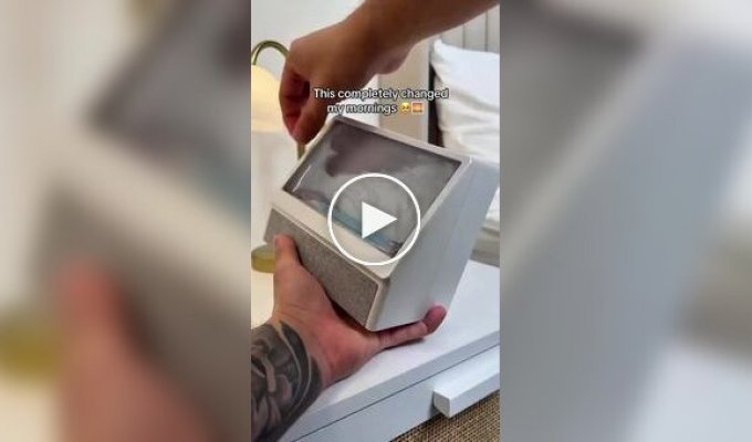 A cozy alarm clock with a simulated sun over the ocean