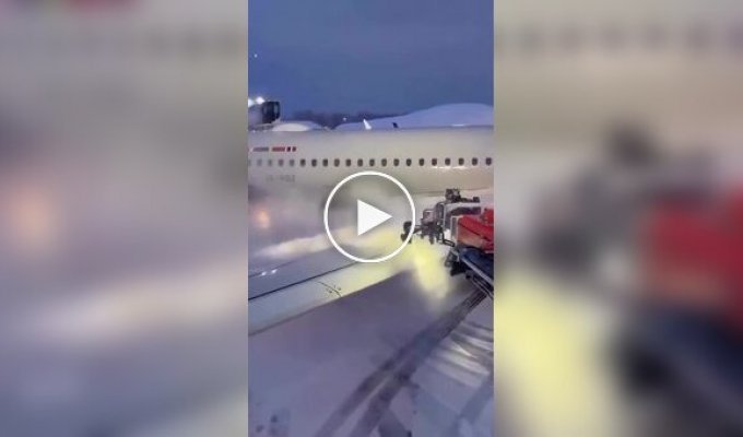 Plane being cleared of snow before takeoff