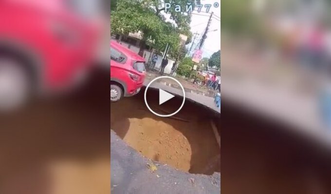 The driver managed to escape when a huge crater appeared under his car.