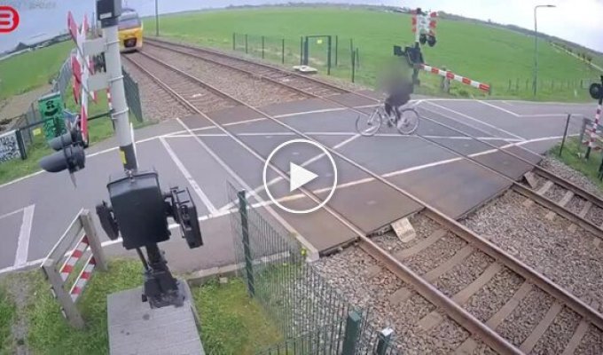 A cyclist narrowly escaped being hit by a train