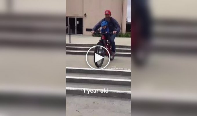 A father-cyclist teaches his one-year-old son to ride a bike